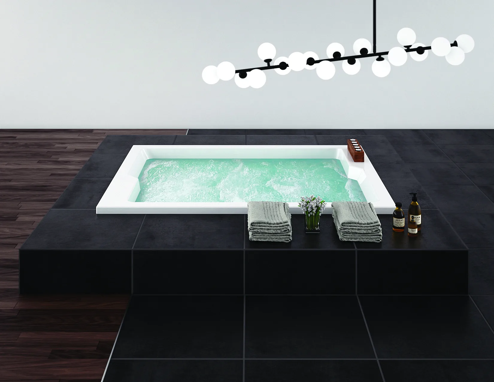 Eingebaute Aquaestil Massagewanne mit sprudelndem Wasser in einem dunkel gefliesten Ambiente